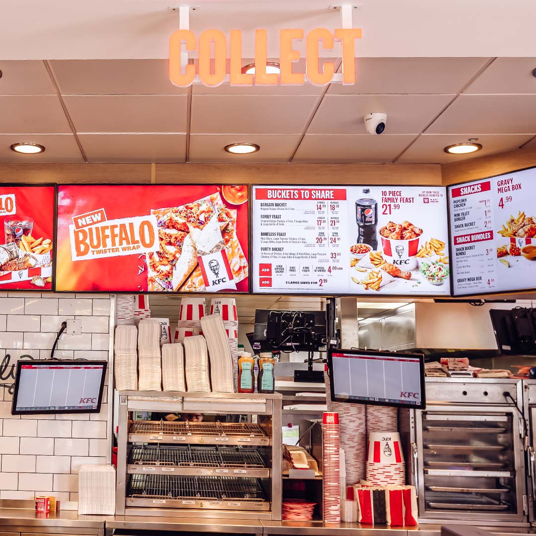 Dual drive thru digital menu screens on a pedestal at a KFC restaurant order point in the UK