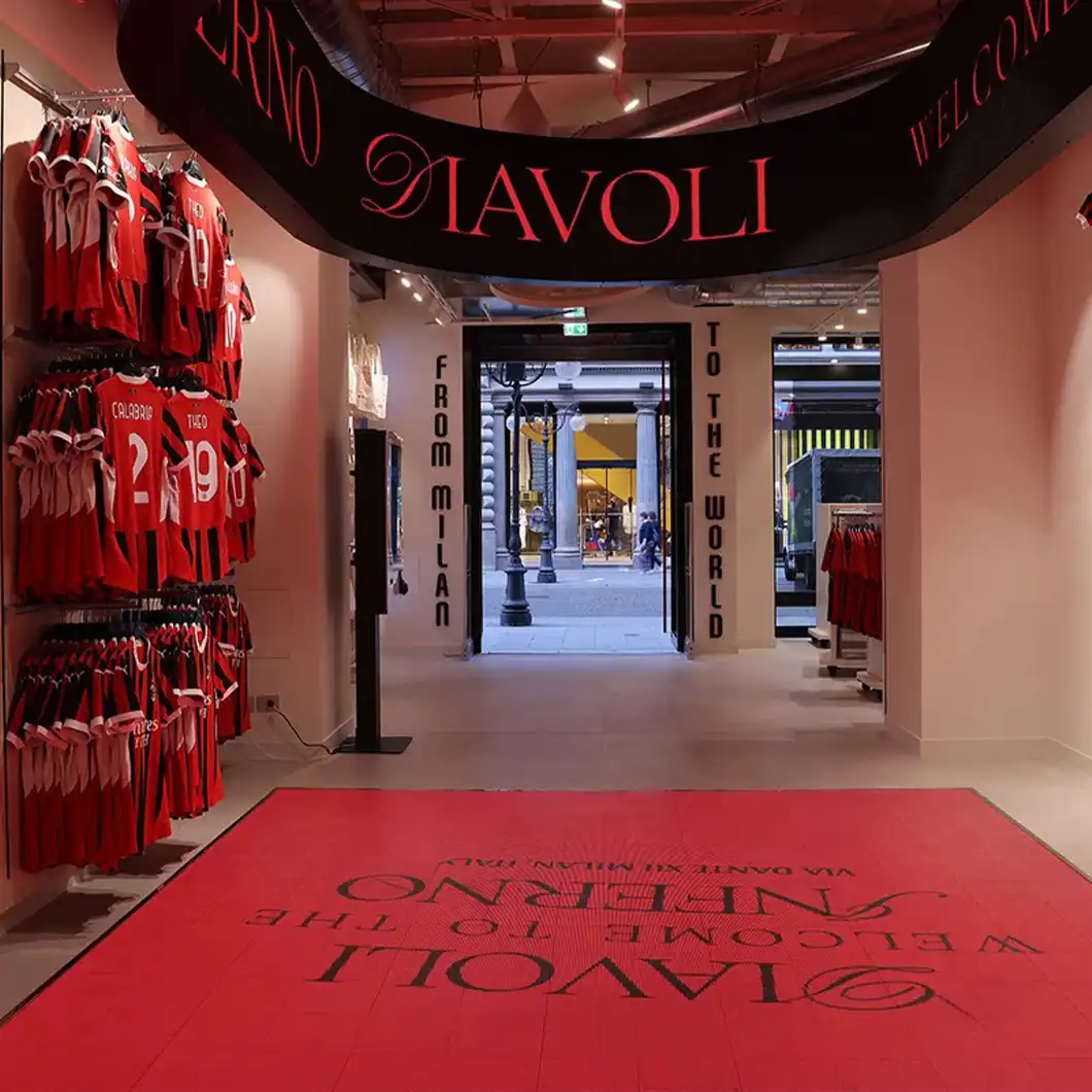 Central store area with LED ring and interactive floor creating immersive fan engagement.