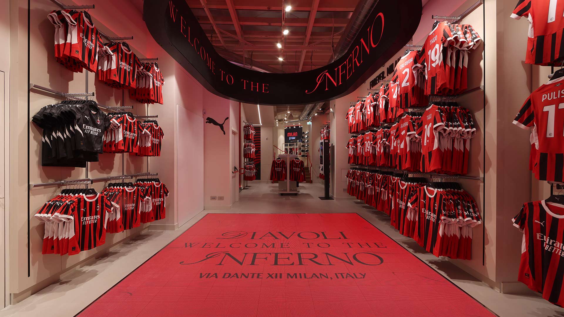 Interactive LED floor display and double-sided LED ring in AC Milan store creating immersive experiences.