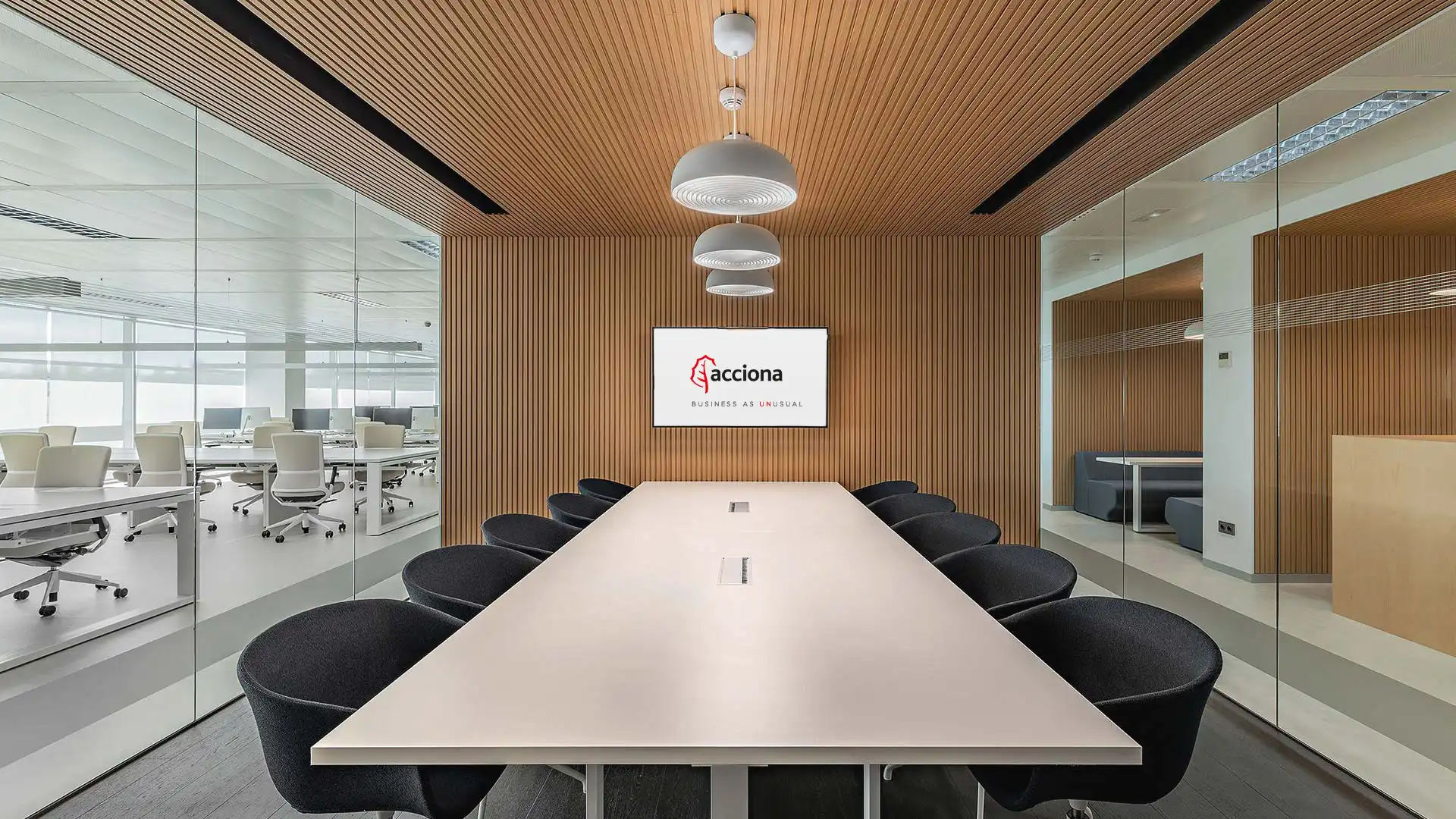 Team collaborating in a smart meeting room equipped with digital whiteboard and audiovisual integration by TRISON.