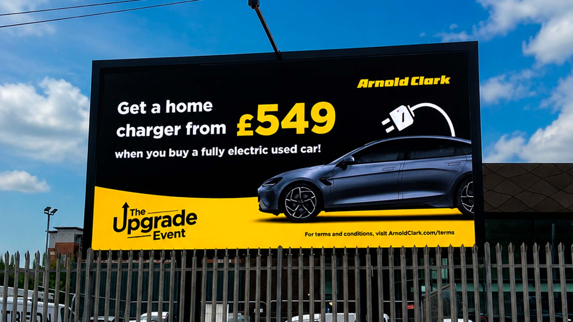 Outdoor LED display showing electric vehicle charger offer at Arnold Clark East Kilbride dealership