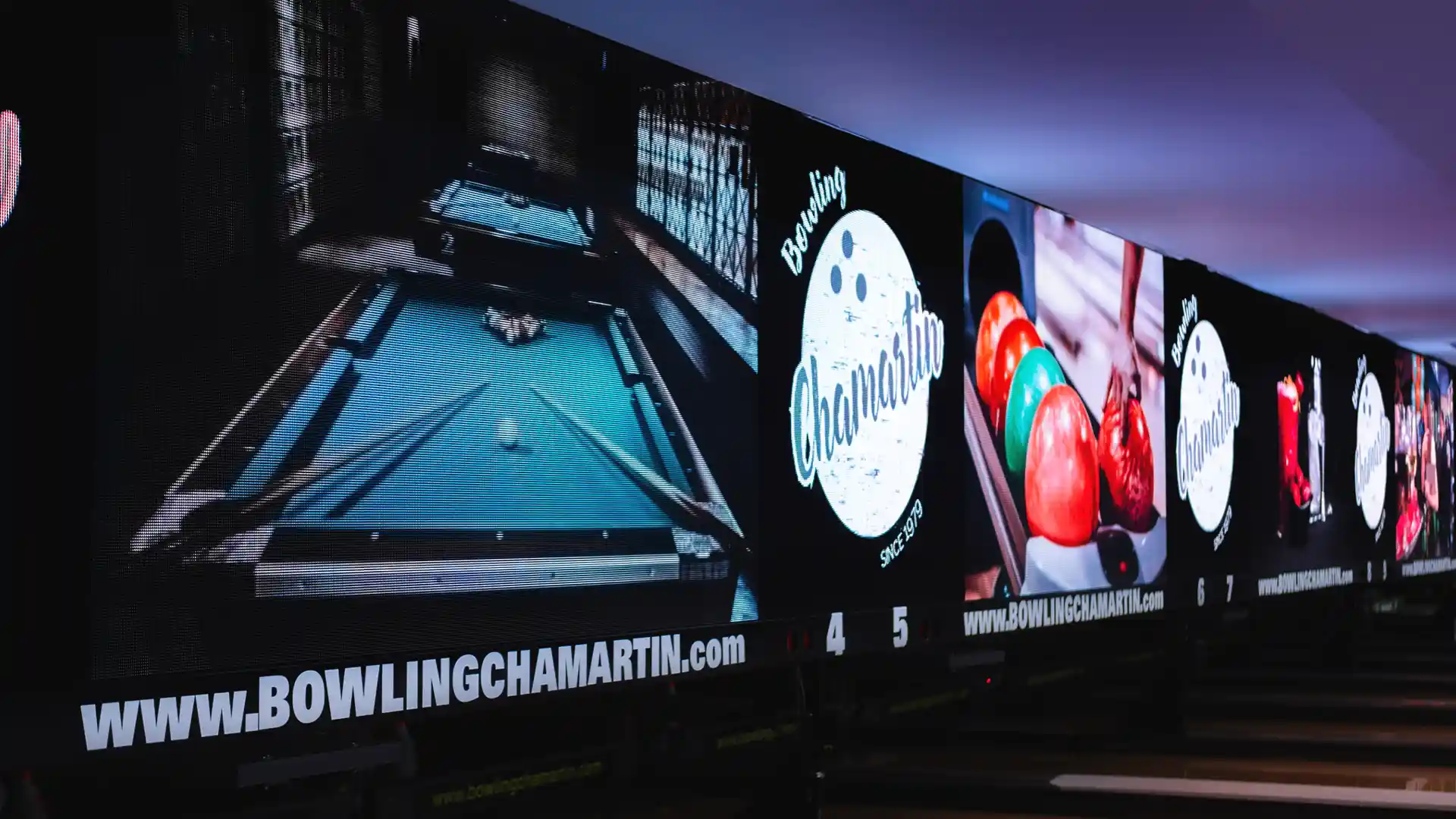Close view of updated bowling lanes with immersive lighting and audiovisual integration.
