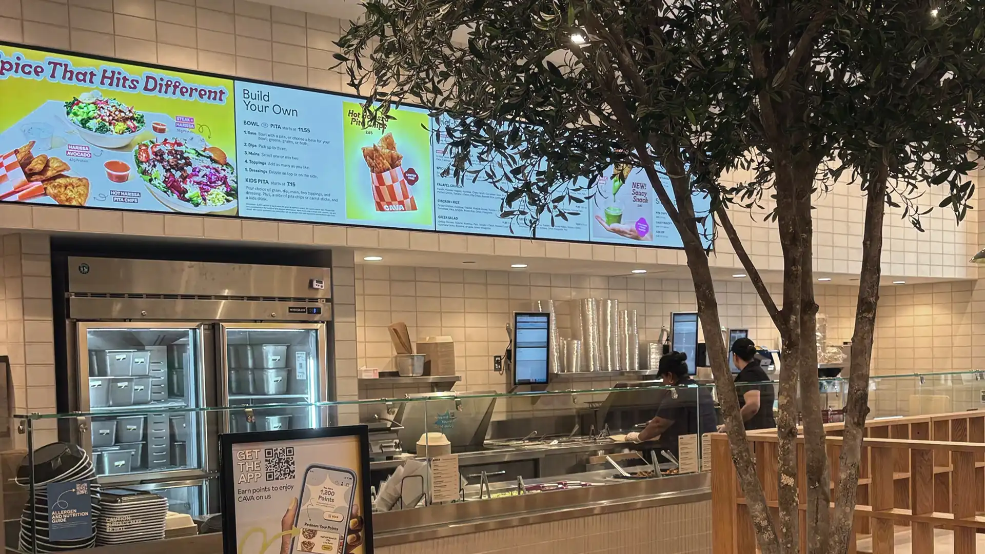 Drive-up digital menu screen at a CAVA restaurant showing real-time updates and healthy Mediterranean offerings.