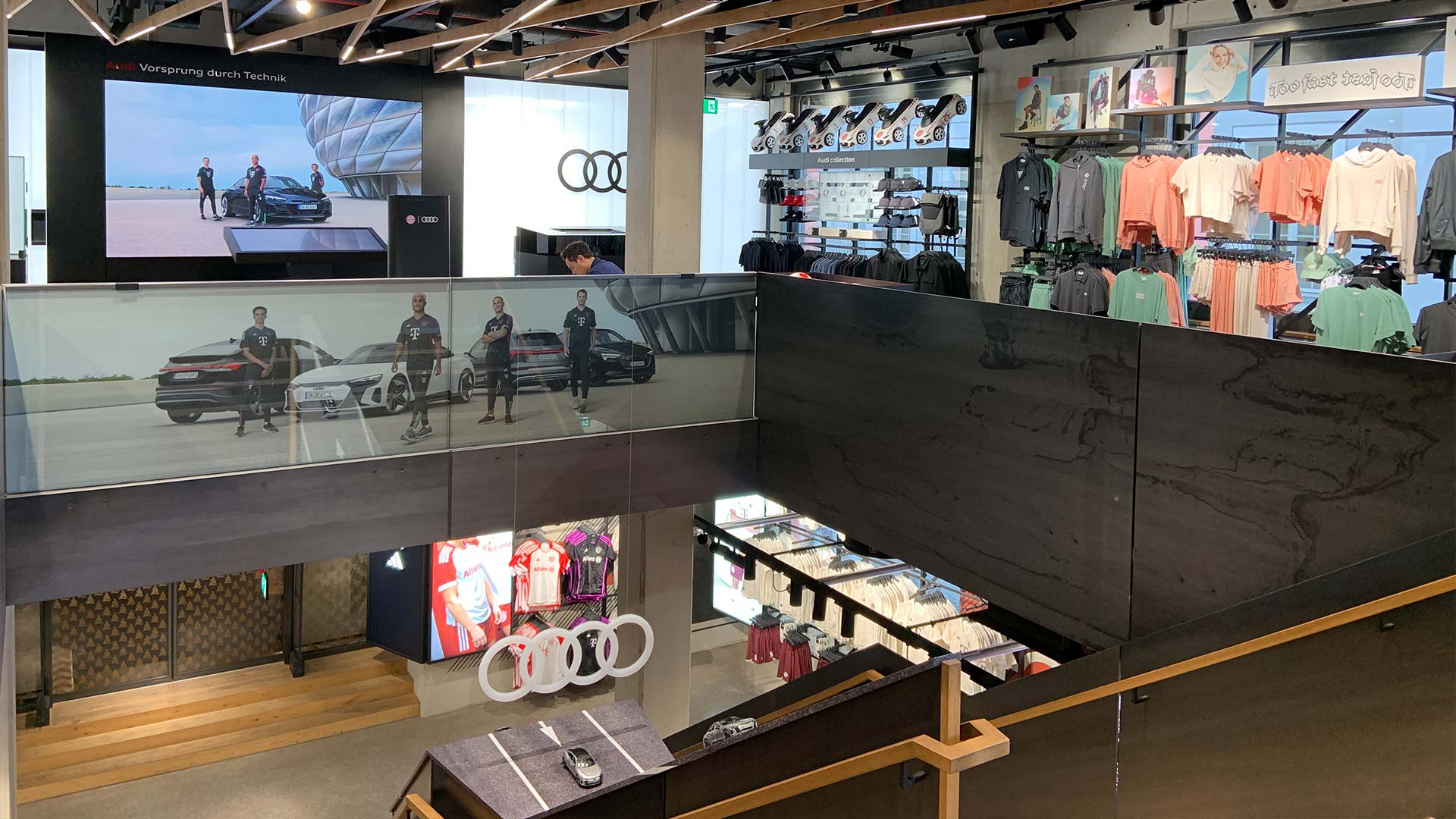 Large-format glass LED display spanning two floors at FC Bayern World Audi Experience zone in Munich