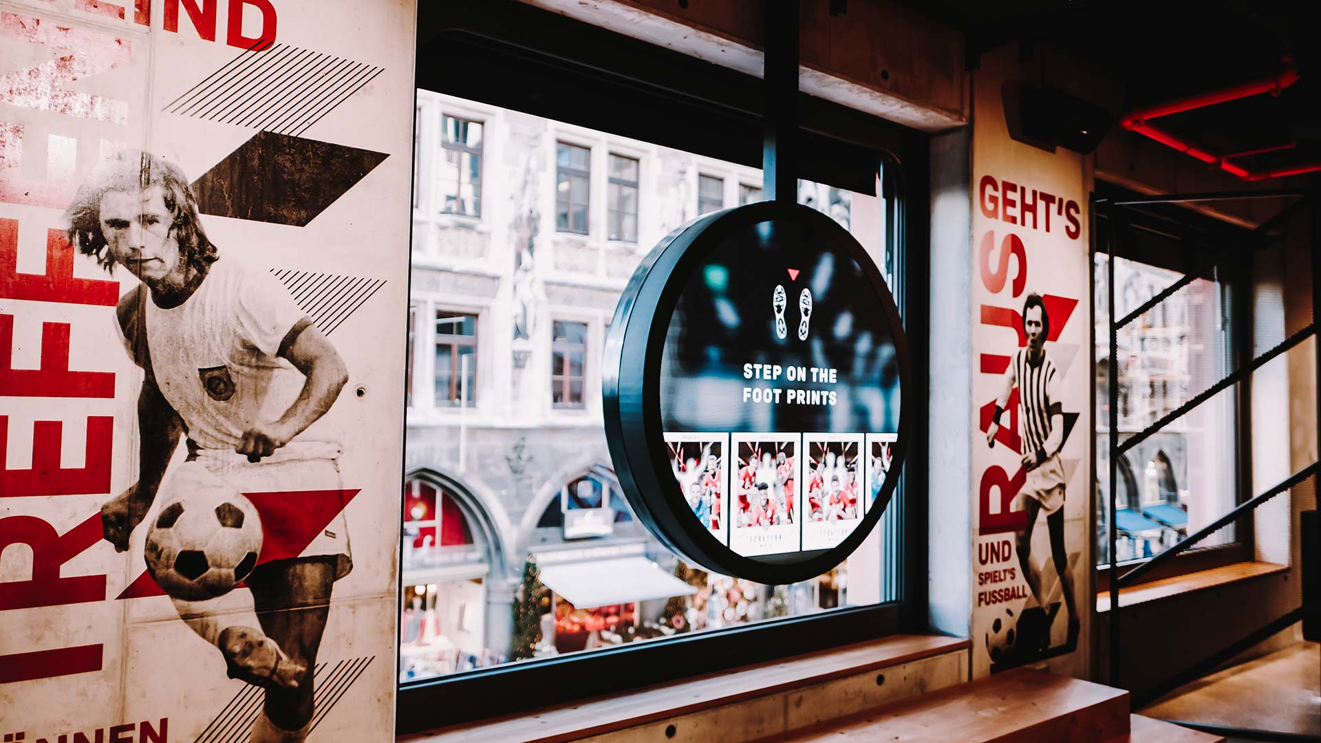 Circular interactive display at FC Bayern World Munich inviting visitors to take a photo with Bayern players