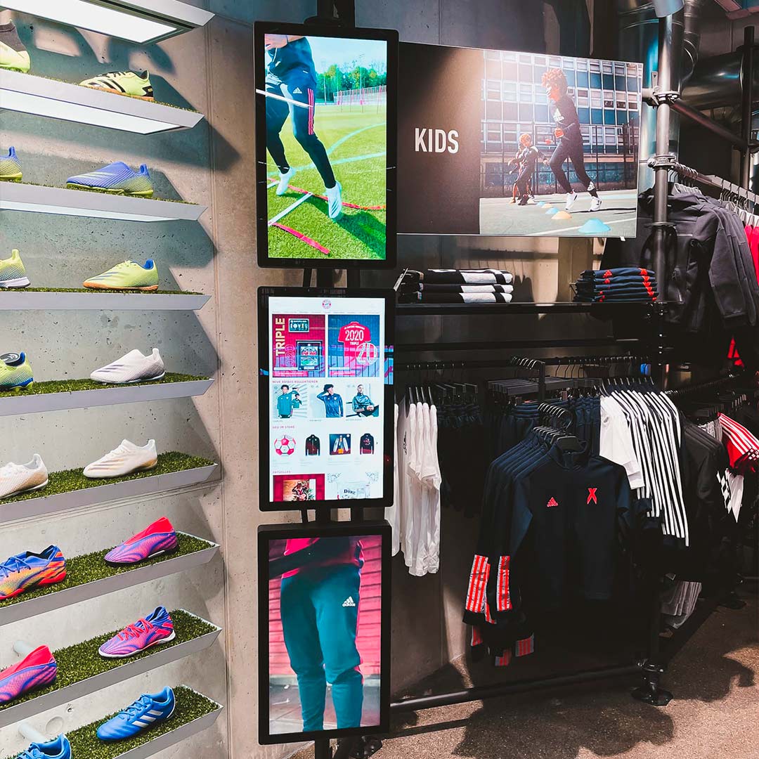 Stacked LCD digital signage displays in Kids section at FC Bayern World flagship store Munich