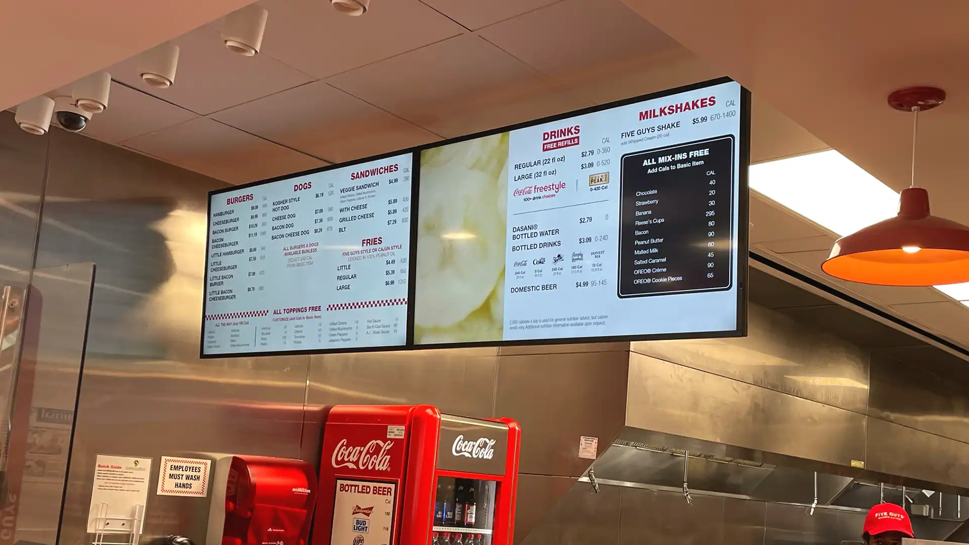 Close-up of digital menu boards at Five Guys restaurant showing clear, dynamic visuals integrated by TRISON North America.