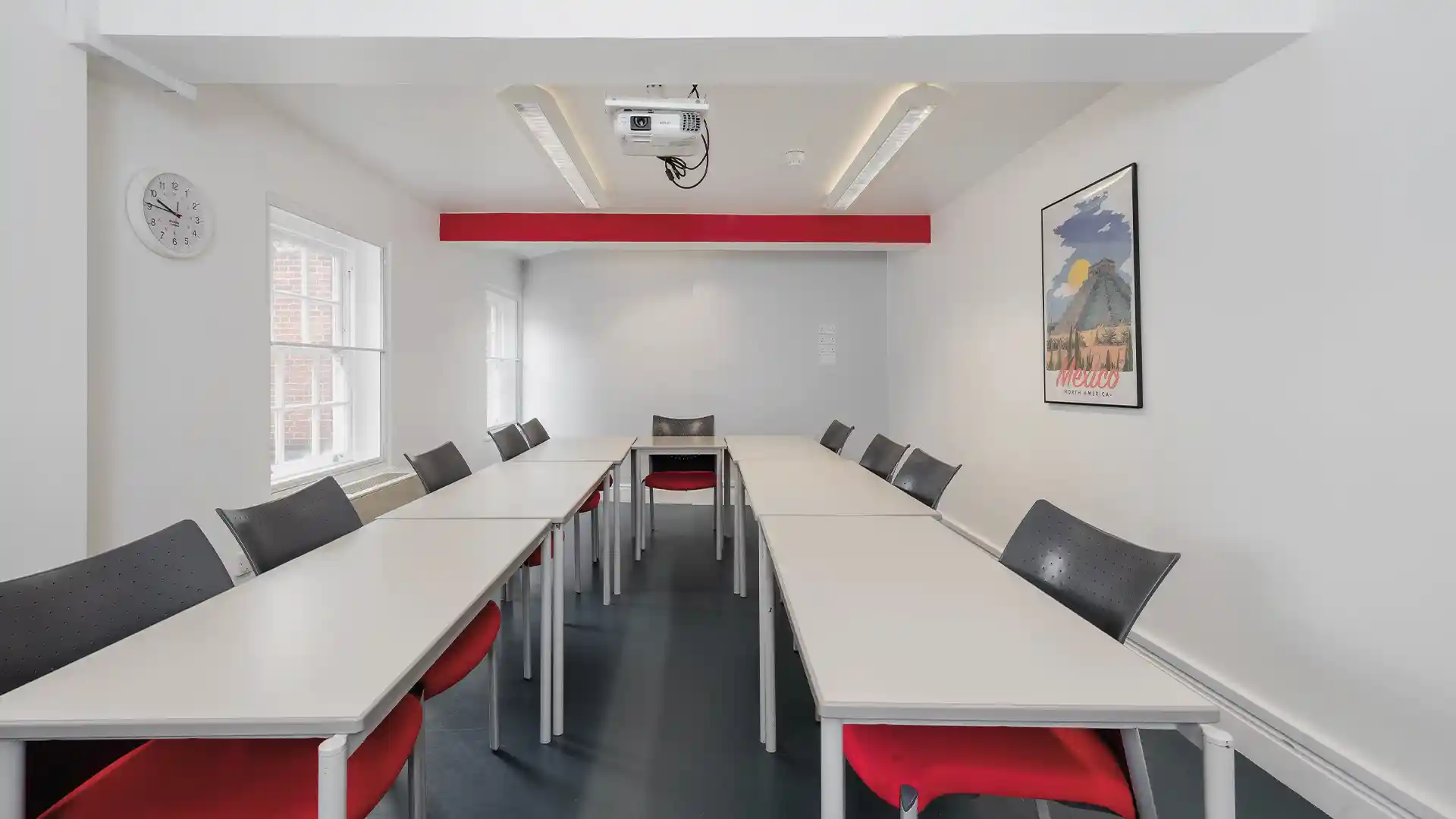 Standardised audiovisual classroom setup at Instituto Cervantes with integrated screens and teaching technology.