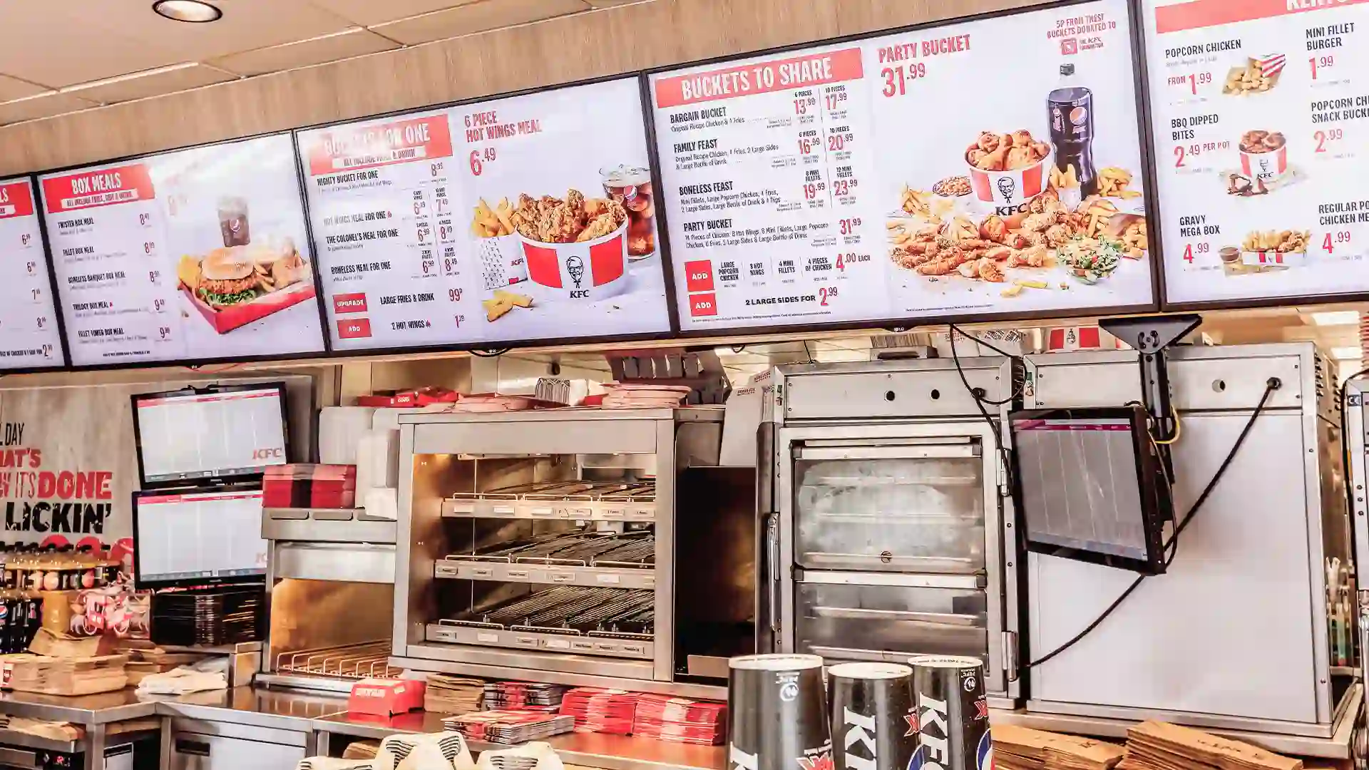 Installing digital drive thru screens at a KFC restaurant.
