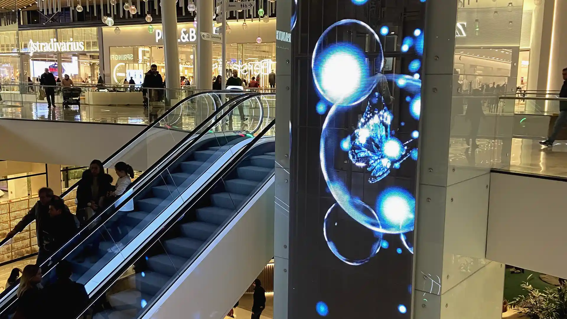 Transparent LED elevators at Lagoh Mall creating a floating visual effect.