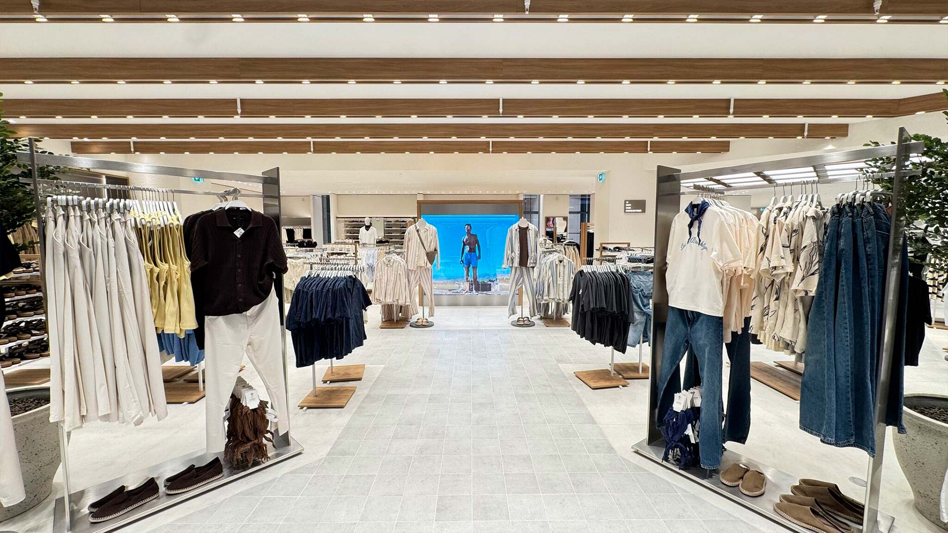 Transparent LED glass display at the end of the menswear aisle in Lefties Bucharest store