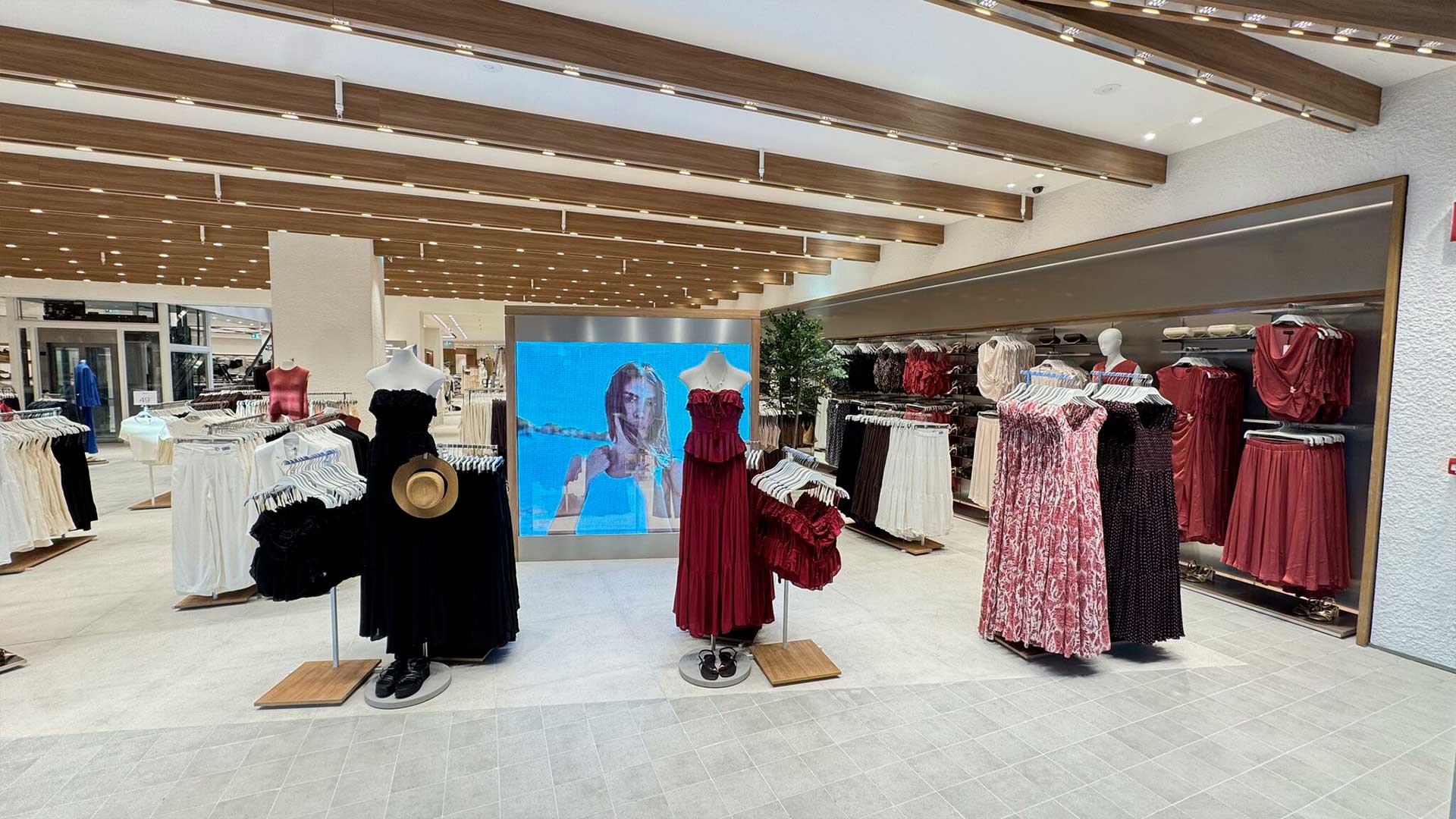 Transparent LED glass display integrated into the womenswear area of Lefties Bucharest store