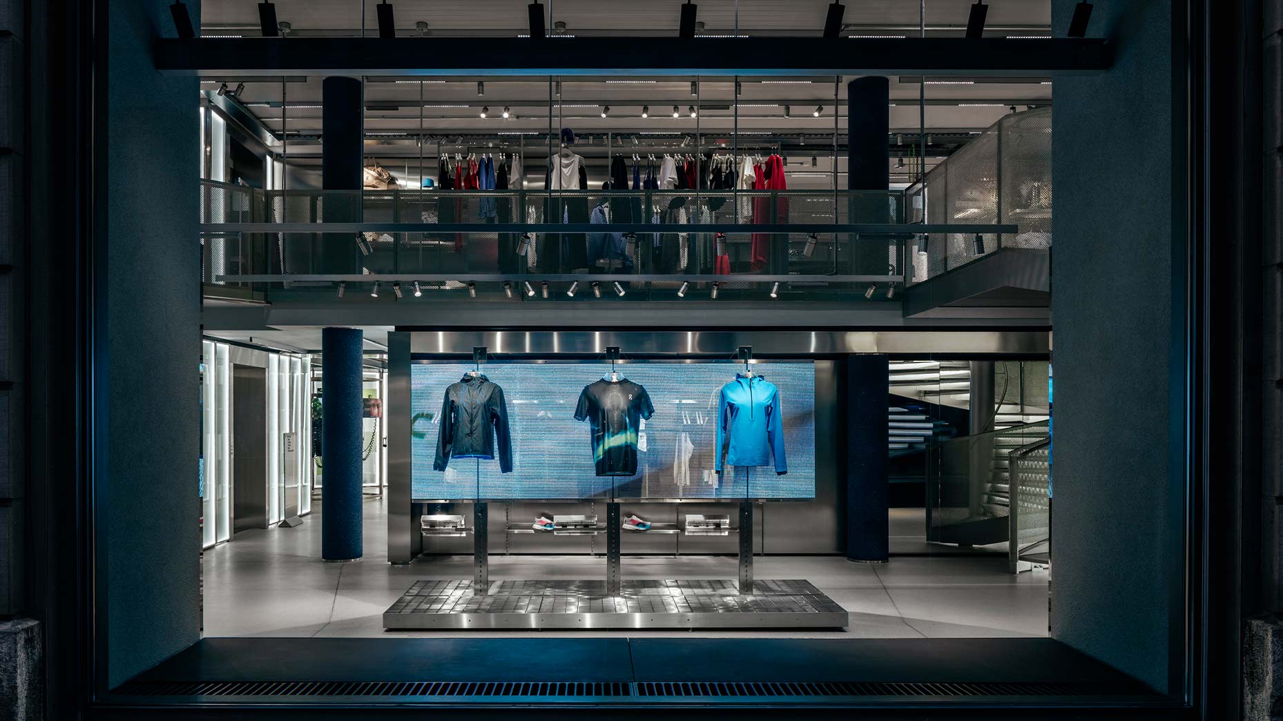 Interior overview of On Running Zurich store showing transparent LED ceiling and circular LED table installed by TRISON