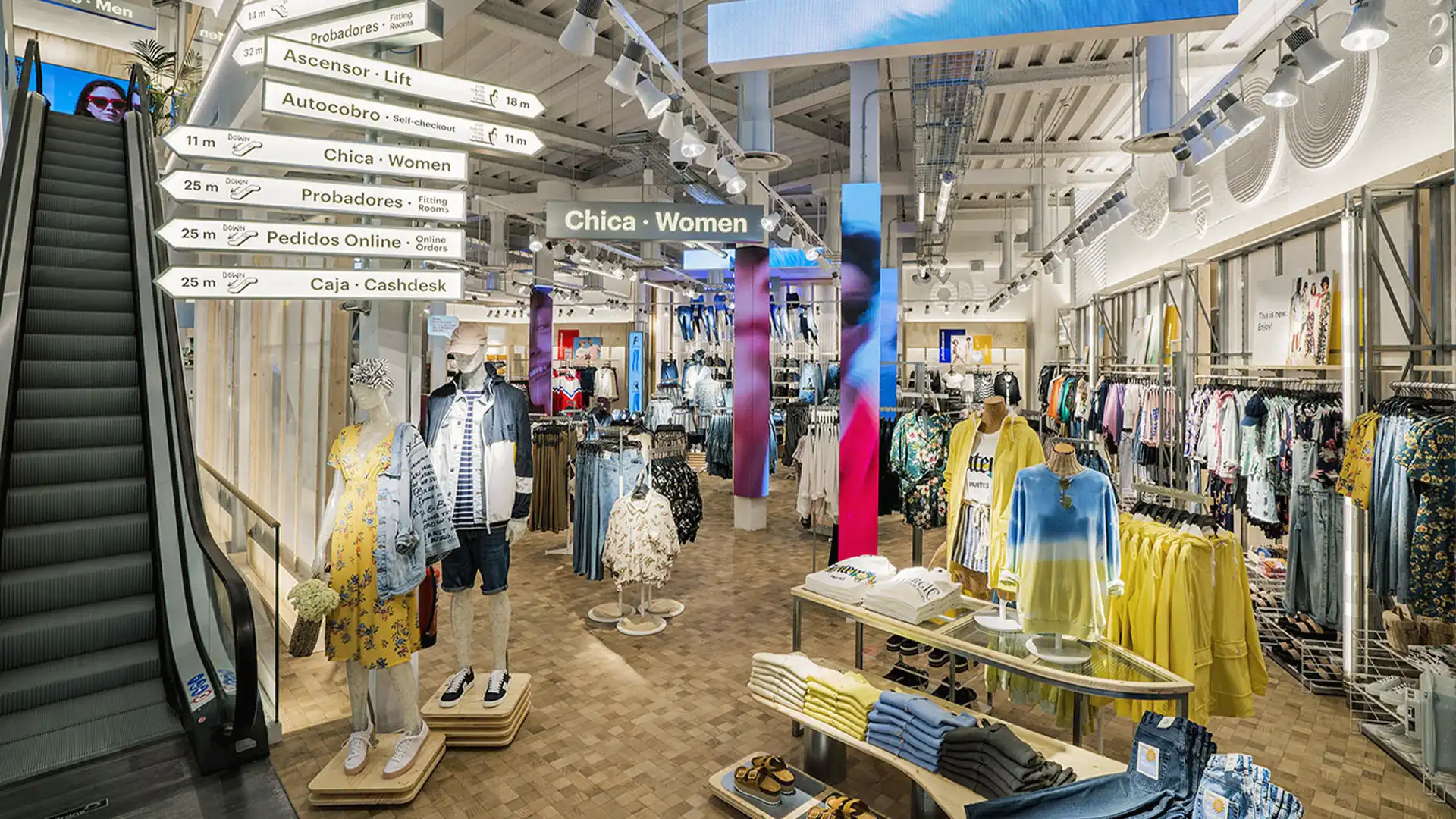 Interior view with large-format LED screens and integrated digital signage.