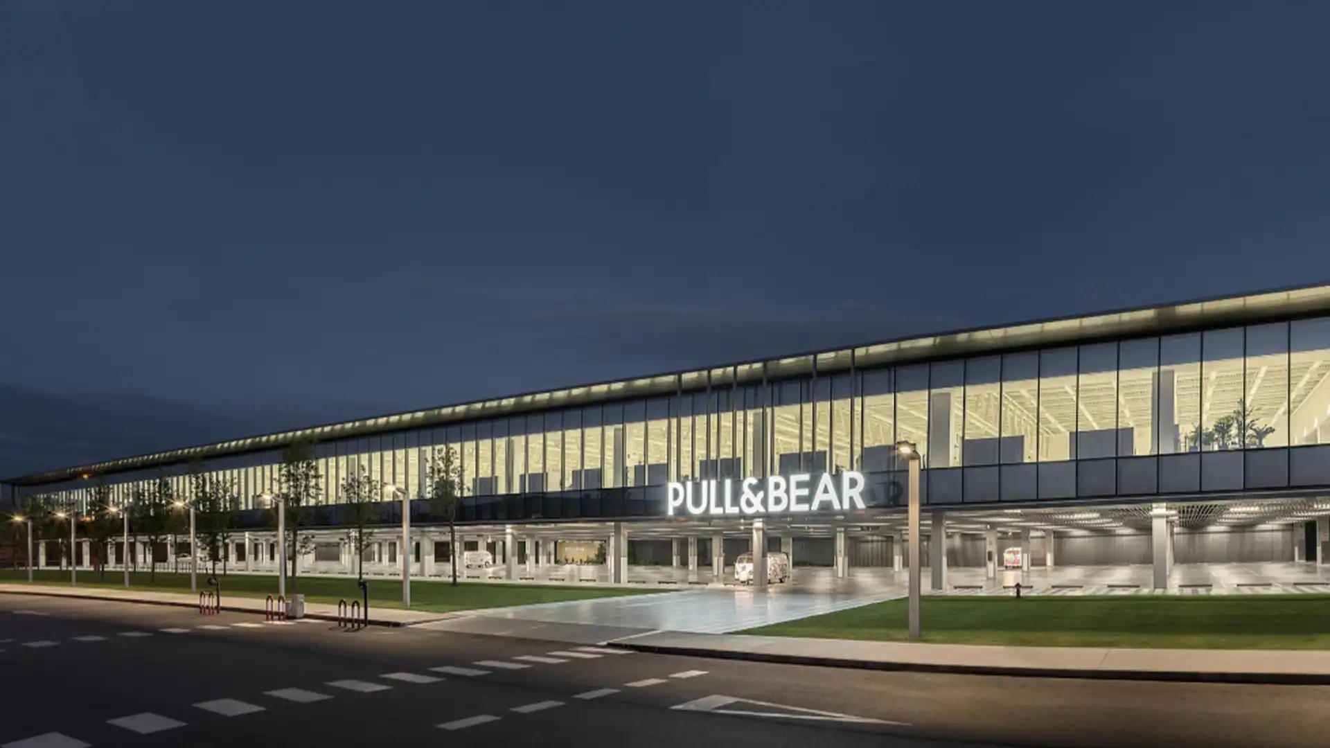 Vue extérieure du siège de Pull&Bear à Narón, avec éclairage LED intégré et conception architecturale futuriste.