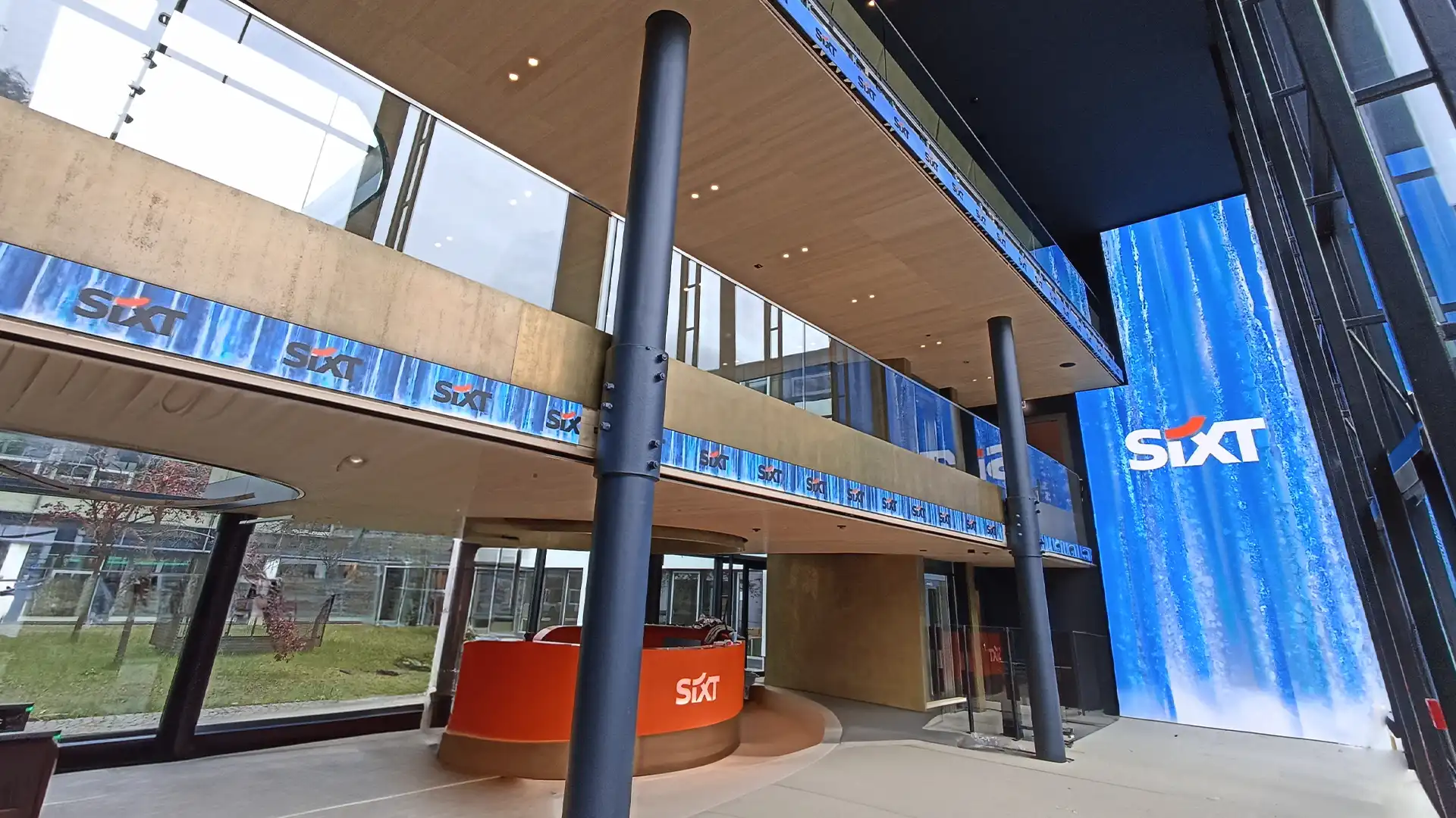 ALT-description 2: 3D digital water animation projected across SIXT’s LED screens in Pullach, illustrating TRISON’s creative content integration.