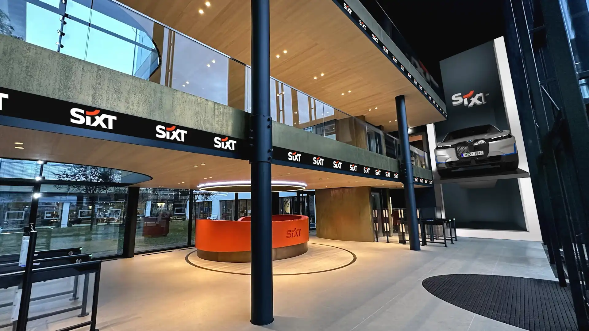 Synchronized digital banners at SIXT Pullach lobby extending LED visuals across the reception area.