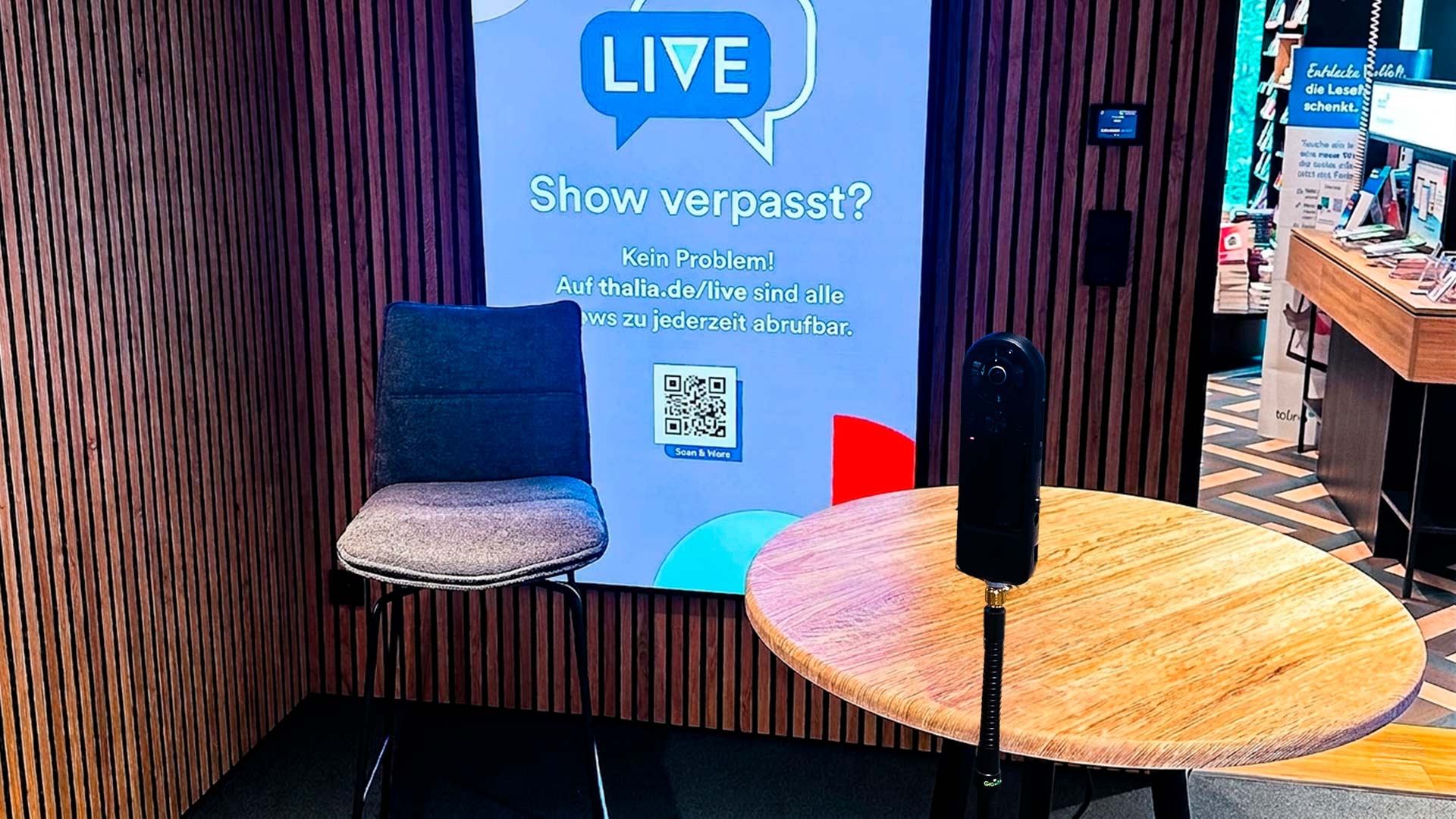 Integrated podcast studio at Thalia Cologne bookstore with professional camera equipment and digital display screen for live broadcasting