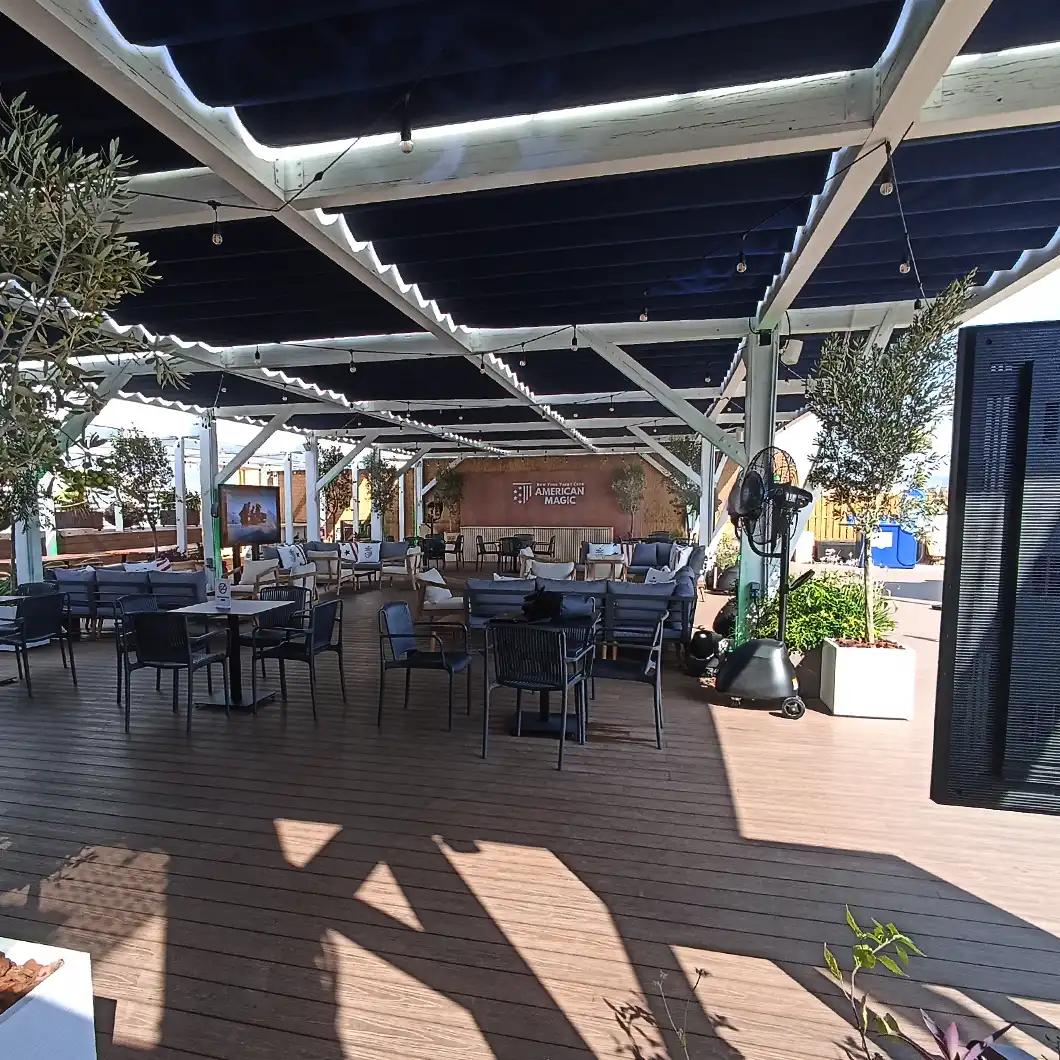 Multipurpose indoor and terrace areas at the American Magic Team Base designed with audiovisual consistency.