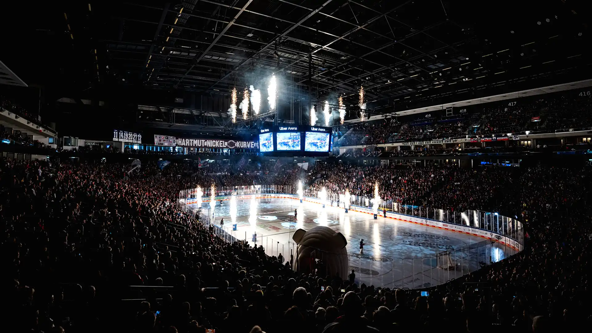 Wide view of Uber Arena with full LED system activated during live entertainment show.